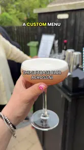 A promotional video for 'The Suitcase Club', a mobile bar service. The video features the bartender preparing various cocktails, including a French Martini, Espresso Martini, and a Sake Surprise Smash, while explaining the service's offering for parties and gatherings.