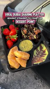 A short, punchy video showcasing a 'viral Dubai sharing platter' from Dessert Point, featuring close-up shots of dipping strawberries, brownies, and fried dough into sauces while inside a car.