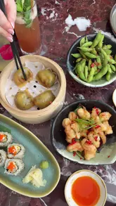 A video review of a rooftop restaurant and bar in West London, featuring a variety of Japanese-inspired fusion dishes, cocktails, and the venue's scenic views. The creator provides commentary on the food and overall vibe, recommending it for celebrations or date nights.