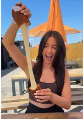 A short, punchy video showcasing a giant half-kilo mozzarella stick from a street food trader. The creator demonstrates the size and the cheese stretch, effectively highlighting the product's appeal.