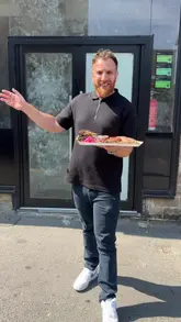 A creator provides a sneak peek of a new smokehouse, Meatbros, located in the Great Horton Food Court in Bradford, showcasing a platter of tender, flavourful smoked meats including brisket and ribs.