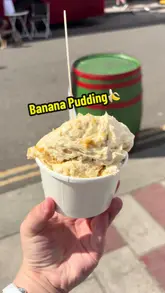 A creator visits a market stall called SpoonMe at the Barras Market in Glasgow to try their banana pudding. The video follows her walking to the stall, showing the menu and the product being served, and concludes with her tasting the dessert.