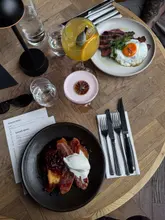 A short promotional video for The Cow and Sow in Birmingham, featuring shots of the restaurant's interior and close-ups of their brunch dishes, including steak and eggs, hash, and French toast.