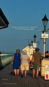 A montage of clips capturing the atmosphere of Penarth promenade during golden hour, featuring the pier, swimmers, and ice cream.