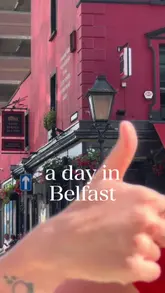 A vlog-style video featuring two creators exploring Belfast, with a specific focus on a pizza spot called Flout. They sample various pizza slices and chat about the food and the city.