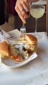 A short, aesthetic montage showcasing the food and atmosphere at Belly, a Filipino-inspired neighbourhood spot in Kentish Town, London. The video highlights the signature tempura cod pandesal, various cocktails, and the casual, stylish interior.