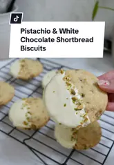 A step-by-step recipe tutorial for making pistachio and white chocolate shortbread biscuits, featuring clear instructions and close-up shots of the baking process.