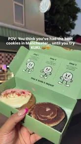A short, punchy reel showcasing a cookie shop in Manchester. The video focuses on close-up shots of the cookies being broken open to reveal a gooey, warm texture, interspersed with shots of the shop's exterior and branding.