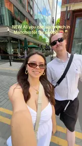 The video is a first-person vlog-style review of a bottomless brunch experience at Sticks'n'Sushi in Manchester. It features the creators enjoying a variety of Japanese dishes, including sushi, beef tataki, and chicken skewers, alongside unlimited drinks. The video highlights the outdoor seating area and the overall dining experience.