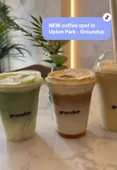 A short, aesthetic montage showcasing the drink preparation and interior of Groundup Society, a new coffee spot in Upton Park. The video highlights specific menu items like the white Spanish matcha, iced caramel latte, and mango banana smoothie, emphasizing the cafe's viral popularity and photogenic appeal.