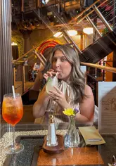 A creator visits a new Indian and Sri Lankan restaurant in Liverpool, showcasing the interior decor, cocktails, various dishes including a lamb rogan josh, and the overall dining experience.