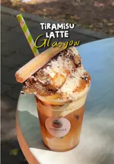 A creator visits Medina's Coffee in Glasgow to try their viral Tiramisu Latte, which is served topped with a full slice of tiramisu.