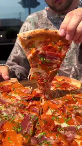 A high-energy food review of Sugo Pizza & Pasta, featuring a variety of dishes including pizza, pasta, arancini, and garlic focaccia. The creator provides a personal, enthusiastic critique of the food, highlighting specific menu items like the vodka sauce and nduja mayo, while showcasing the venue's casual atmosphere and ordering process.