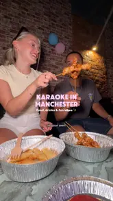 A lively vlog-style reel showcasing a visit to a karaoke venue in Manchester. The video highlights the private karaoke rooms, the ordering system for food and drinks, and the overall social experience, including playing games like darts.