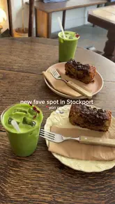 A short, handheld vlog-style video showcasing a cafe in Stockport, featuring matcha lattes and chocolate chip banana bread.