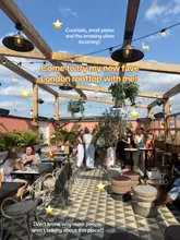 A wide-angle shot of a rooftop terrace at The Hoxton in Shoreditch, capturing the lively atmosphere and decor. The image features patrons enjoying the space, with text overlays promoting the venue's cocktails, small plates, and overall vibe.