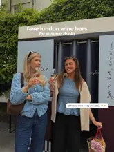 A lifestyle-focused image featuring two women holding glasses of rosé wine, likely taken at a London wine bar. The image is bright, clear, and captures a social, summery atmosphere suitable for promoting hospitality venues.