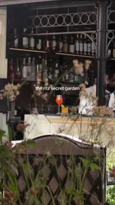 A high-quality, aspirational video showcasing the 'Secret Garden' at The Ritz London. The footage captures the elegant outdoor terrace, the sophisticated atmosphere, and a variety of high-end dishes and cocktails, including wagyu sando with caviar, pasta, and desserts. The video effectively uses a vlog-style perspective to guide the viewer through the experience, from lunch to evening drinks.