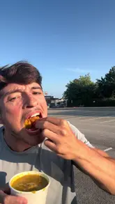 The video features a creator reviewing fried chicken from Yang Sing, providing a casual taste test and rating the dish 7.2/10. The content is shot in a vlog style, primarily focusing on the creator's reaction and commentary while eating the food in a car park setting.