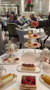 A cinematic, slow-paced reel showcasing the 'Strawberry Season Afternoon Tea' at The Langham London. The video features high-quality shots of the elegant dining room, the tiered tea service, and close-ups of the sandwiches, pastries, and scones, emphasizing the luxury and attention to detail of the experience.