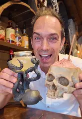 A review of Rhum Tavern in London, a rum-focused cocktail bar with a strong pirate theme. The creator highlights the immersive decor and unique serving vessels for their cocktails, including a flaming coconut and a skull-shaped glass.