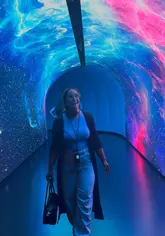 A promotional video for The TIMEWALK Exhibition at ExCeL London, featuring a walkthrough of various immersive 360-degree projection rooms depicting historical civilizations and cosmic themes.