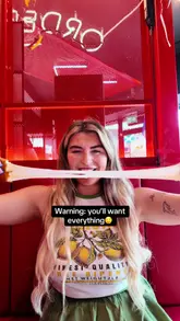 A fast-paced, vlog-style review of Lucky B's Hot Chicken in Glasgow. The creator and her friend sample a variety of items including cheese sticks, chicken tenders, burgers, loaded fries, and milkshakes, highlighting the customizable heat levels and the fun, casual atmosphere of the restaurant.