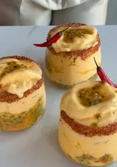 A recipe tutorial for a spicy mango and coconut frozen margarita, featuring step-by-step instructions on blending ingredients and garnishing the glass with Tajín and passionfruit.