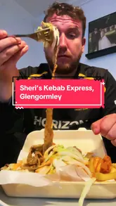 A creator visits Sheri's Kebab Express in Glengormley, Northern Ireland, to review their £7.95 meal deal. The video features a walk-through of the shop, a look at the menu, a glimpse of the food preparation, and a taste test of the donner kebab and chips.