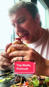 A creator visits Top Blade in Portrush, Northern Ireland, providing a review of the venue, the food (Hickory Burger, Salt and Chilli Fries, Kid's Meal), and the pricing. The video features a seaside view and a casual, family-friendly atmosphere.