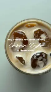 A clean, top-down, aesthetically pleasing shot of an iced coffee, likely taken at Sorcerer Coffee in Newcastle. The image is bright, well-lit, and focuses on the drink, creating an inviting atmosphere for a casual coffee stop.