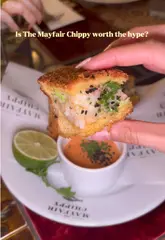 A review of The Mayfair Chippy in London, showcasing various starters, mains, and desserts, with a focus on the prawn toast and classic fish and chips.