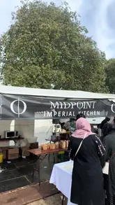 A short video showcasing a food stall at a festival, highlighting the preparation and consumption of a 'Paratha Smash Burger' by Midpoint Imperial Kitchen.