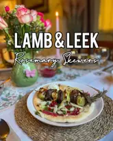 A home-cooked meal featuring lamb and leek skewers served on flatbread with a side salad, presented in a domestic dining setting.