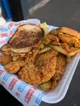 A short promotional video for the newly opened Dairy King branch in Sutton Coldfield, featuring close-up shots of their fried chicken tenders, chicken sandwich, and fries.
