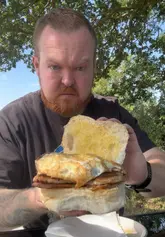 A vlog-style review of a countryside pop-up cafe called Route 41, highlighting the relaxed atmosphere, outdoor seating, and breakfast baps.
