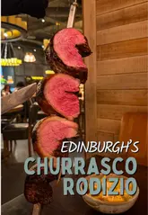 A review of Fogo de Chao in Edinburgh, showcasing the Brazilian rodizio steakhouse experience, including the meat service, seafood platter, lobster mac and cheese, and cocktails.