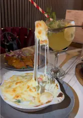 A review of The Woodlands Steak & Grill in Blackburn, showcasing the venue's interior and a variety of dishes including starters, steaks, and desserts.
