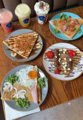 A montage video showcasing the preparation and presentation of sweet and savoury crêpes, smoothies, and milkshakes at Prep' La Crêpe in Market Halls Oxford Circus.