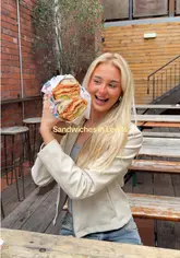 A vlog-style review of 'Granny G's' deli located within the 'Green Room' venue in Leeds. The creators showcase the massive size of their sandwiches, including the chicken parm, meatball, and BMT, while highlighting the venue's atmosphere and kitchen preparation.