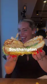 A vibrant, vlog-style review of HarBAR on 6th in Southampton, highlighting the rooftop setting, scenic views, and a selection of menu items including a seafood burger, prawn starter, beef sausages, steak, and dessert.