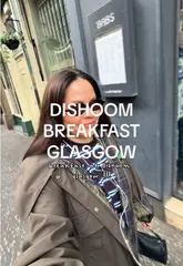 A vlog-style review of a breakfast visit to Dishoom in Glasgow, showcasing the interior, menu, food, and merchandise.