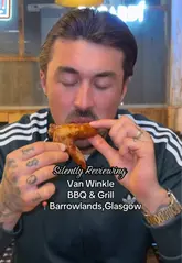 A couple visits Van Winkle BBQ & Grill in Glasgow, showcasing the venue's atmosphere, cocktails, and a variety of BBQ-style dishes including haggis bon bons, ribs, wings, and chicken and waffles.