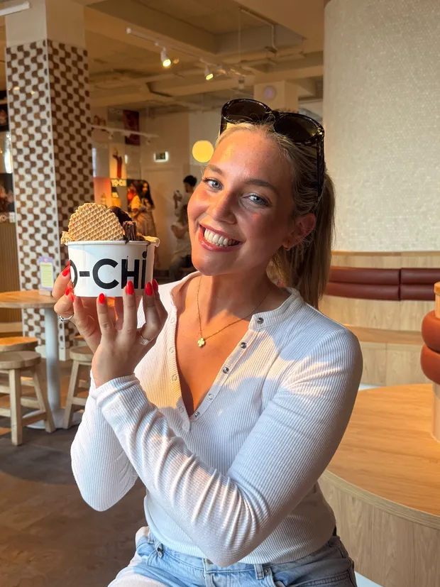 Izzy, Joli’s marketing manager, holding an ice cream in a café